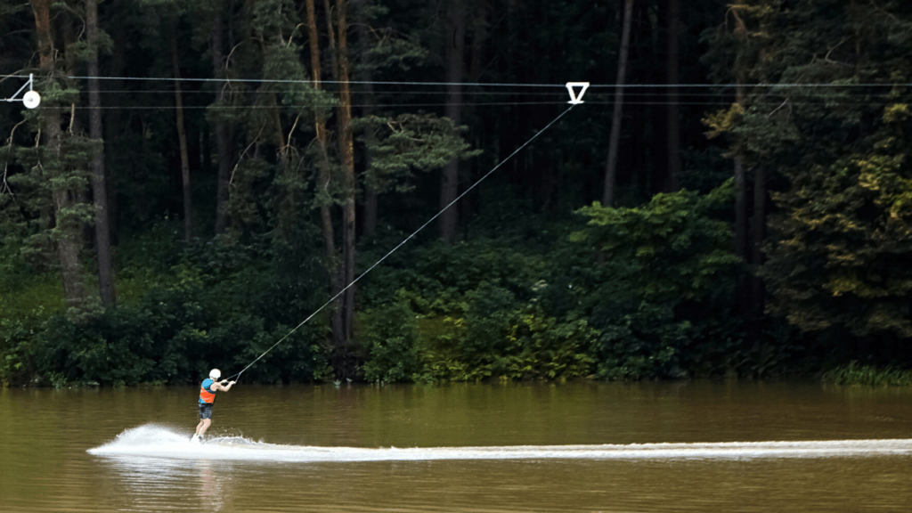 wakeboarding being pulled on a cable